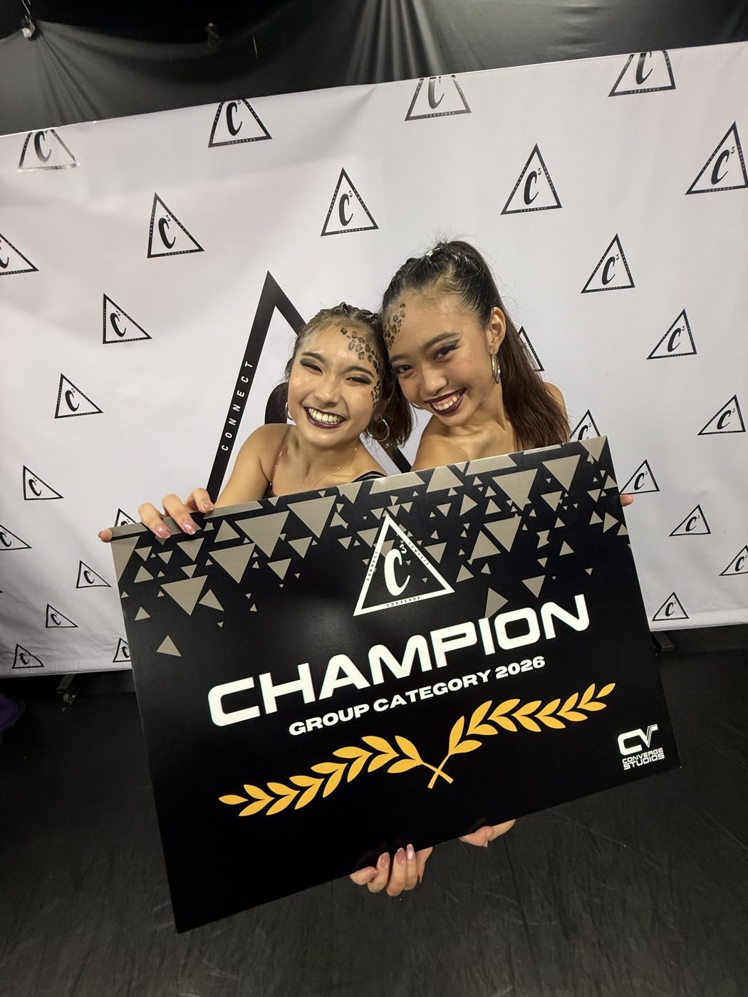 Holding the 2026 group category champion board